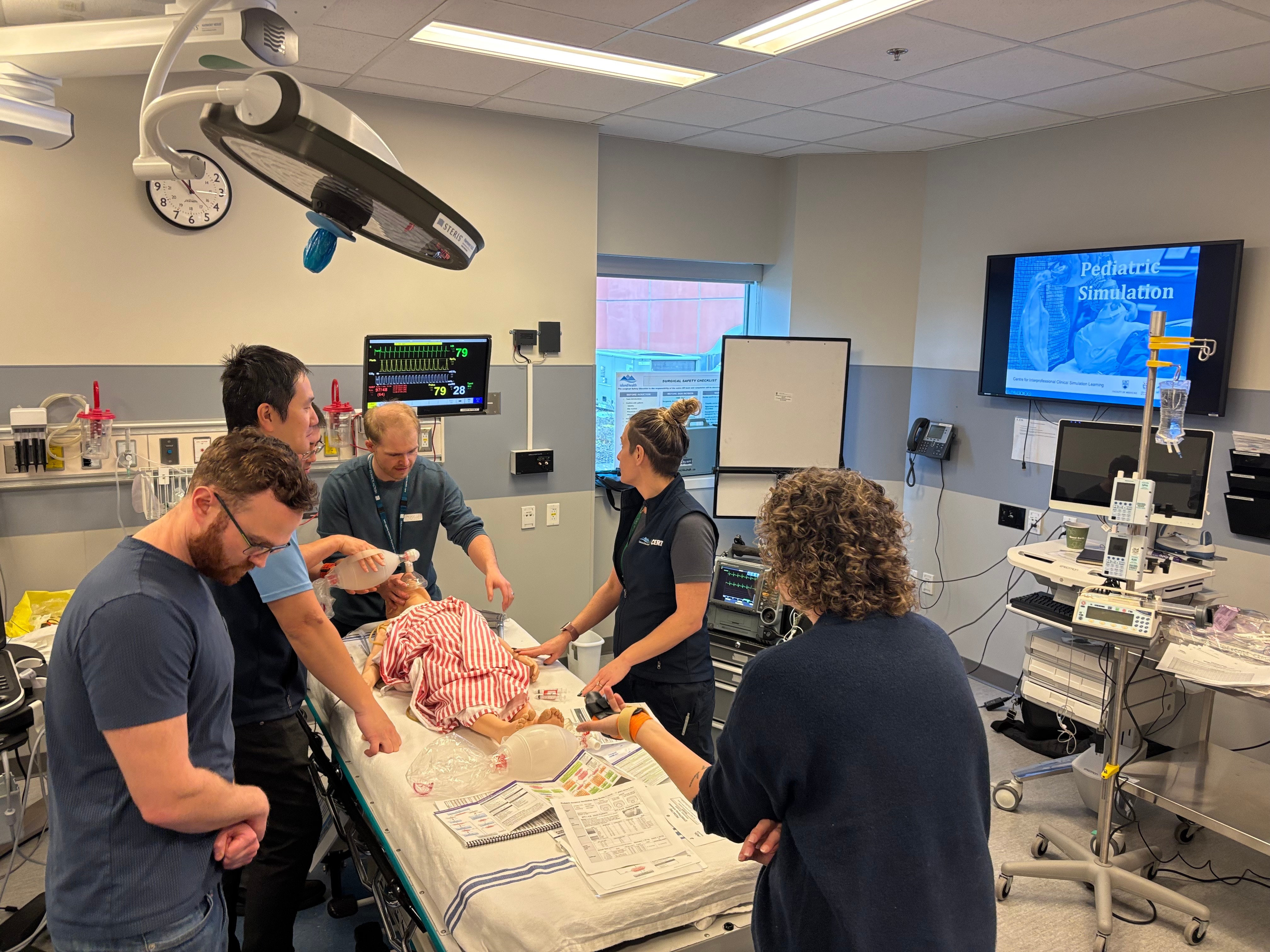 team of five  in sim practicing procedure.jpg