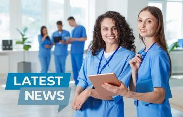 two people in scrubs looking at the camera